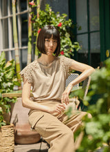 Load image into Gallery viewer, The Lyssé Katarina Eyelet Sleeve Trim Top is a refined yet effortless short-sleeve blouse featuring delicate eyelet-trimmed sleeves for a touch of elegance. Designed with a relaxed silhouette, this top offers both comfort and sophistication, making it a versatile addition to any wardrobe.
