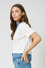 Load image into Gallery viewer, Woman wearing a white knitted and denim collared and hem short sleeve top and blue jeans against a plain background.