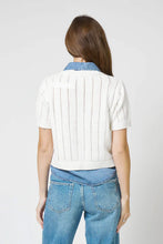 Load image into Gallery viewer, Woman wearing a white knitted and denim collared and hem short sleeve top and blue jeans against a plain background.