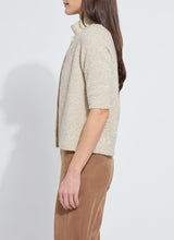 Load image into Gallery viewer, Model wearing a feather yarn, gold lurex knitted cardigan and brown pants against a white background.