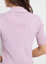 Load image into Gallery viewer, The Kenzie Ribbed Knit Polo in Rose Shadow is a stylish and versatile addition to your wardrobe. Crafted from Sculpting Rib Knit, this form-fitting sweater features a polo collar and short sleeves, making it perfect for both casual and semi-formal occasions. The rose shadow color adds a touch of elegance, while the stretchable fabric ensures comfort and a flattering fit. Ideal for those seeking a chic and modern look, our Kenzie pairs beautifully with jeans, skirts, or trousers.