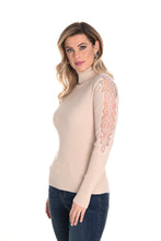 Load image into Gallery viewer, Enhance your wardrobe with the sophisticated Brixley knit sweater. This beige turtleneck features exquisite lace detailing on the arms, elevating its style. Combining comfort and charm, the Brixley is ideal for layering or standalone wear. Its neutral hue adds versatility to any outfit.