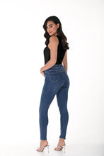Load image into Gallery viewer, Woman modeling the back of a black camisole tank, blue jeans and heels against a white background.
