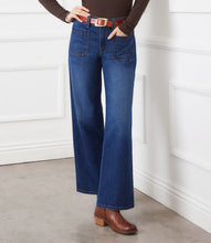 Load image into Gallery viewer, Model wearing blue jeans with patch pockets, brown belt, brown top and brown boots against a white background.