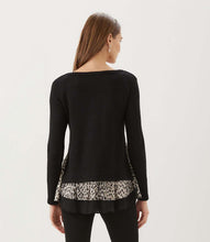 Load image into Gallery viewer, A woman viewed from the back wearing a black long-sleeve top with a leopard-print ruffled hem, paired with black pants, against a plain white background.