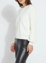 Load image into Gallery viewer, Crafted from cozy jacquard, the Leanna Cozy Pearl Sweater features strategically placed cables on the front and sleeves, a crew neck, and a square, cropped fit. White pearls are hand-stitched between the cables on the sleeves employing a gradient effect. You will feel and look fabulous when styling this top with any of your favorite bottoms.