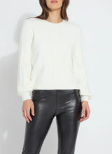 Load image into Gallery viewer, Crafted from cozy jacquard, the Leanna Cozy Pearl Sweater features strategically placed cables on the front and sleeves, a crew neck, and a square, cropped fit. White pearls are hand-stitched between the cables on the sleeves employing a gradient effect. You will feel and look fabulous when styling this top with any of your favorite bottoms.