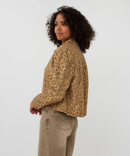 Load image into Gallery viewer, Woman wearing a leopard print jacket and beige pants against a white background.
