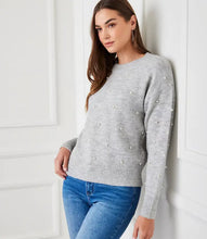 Load image into Gallery viewer, Experience warmth and elegance this winter with our light heather gray pearl crewneck sweater. Adorned with pearl details on the front and arms, this cozy and chic garment is suitable for any event. From formal occasions to casual outings, this sweater is sure to receive admiration.