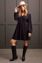 Load image into Gallery viewer, The Lucinda dress combines elegance with convenience, offering generous pockets that merge style with functionality. It showcases a refined v-neckline, complemented by a collar with intricate blanket stitch detailing, sophisticated long sleeves with elasticized cuffs, and a 36" length that gracefully falls just above the knee. This exquisite garment is crafted from superior lightweight ponte fabric.