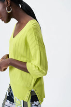 Load image into Gallery viewer, All eyes are on this striking lime green top designed by Joseph Ribkoff. Made from a lightweight summer sweater knit, our Lydia top offers a touchable texture that is super soft against the skin. A v split on each side is enhanced with silver rivet accents, while the V-neck design allows you to show off your favorite jewelry pieces. Color - Lime 3/4 Sleeve. Lightweight sweater knit.