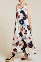 Load image into Gallery viewer, Elevate your warm-weather style with this deep blue floral maxi dress that exudes breezy elegance. Boasting a fully lined interior, sleeveless design, and convenient side-seam pockets, this dress is crafted from printed challis fabric with contrasting straps for a chic touch. With its effortless comfort and low-maintenance appeal, it's the perfect addition to your spring/summer wardrobe.