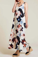 Load image into Gallery viewer, Elevate your warm-weather style with this deep blue floral maxi dress that exudes breezy elegance. Boasting a fully lined interior, sleeveless design, and convenient side-seam pockets, this dress is crafted from printed challis fabric with contrasting straps for a chic touch. With its effortless comfort and low-maintenance appeal, it's the perfect addition to your spring/summer wardrobe.