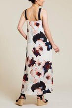 Load image into Gallery viewer, Elevate your warm-weather style with this deep blue floral maxi dress that exudes breezy elegance. Boasting a fully lined interior, sleeveless design, and convenient side-seam pockets, this dress is crafted from printed challis fabric with contrasting straps for a chic touch. With its effortless comfort and low-maintenance appeal, it's the perfect addition to your spring/summer wardrobe.