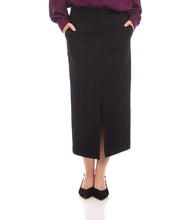 Load image into Gallery viewer, Model wearing a long black skirt with a front slit, purple blouse and black heels against a white background.