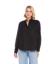 Load image into Gallery viewer, Woman wearing a black blouse with embellishments and light blue jeans on a white background.