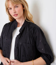 Load image into Gallery viewer, Woman wearing a black blouse with embellishments over a white top against a white wall.