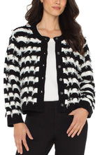 Load image into Gallery viewer, Model wearing a black and white checkered fringe cardigan over a white shirt and black pants against a white background.