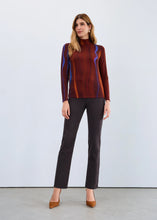 Load image into Gallery viewer, Woman wearing a multicolor long sleeve top, black pants and brown heels against a white background.