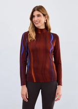 Load image into Gallery viewer, Woman wearing a long-sleeve top with a multicolor pattern and black pants against a white background.