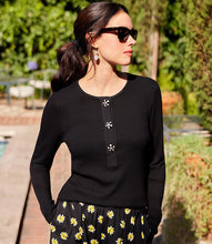 Load image into Gallery viewer, Woman wearing a black long sleeve top with floral pants and sunglasses in an outdoor setting.