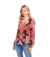 Load image into Gallery viewer, Woman wearing a colorful patterned blouse and blue jeans against a white background.