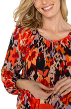 Load image into Gallery viewer, Experience the allure of nature with our elegant long-sleeve shirred woven blouse, featuring a lively burnt orange floral print. Made from a delicate woven fabric, this blouse flows beautifully, providing comfort and allowing breathability. This vibrant color top features long sleeves, ideal for day-to-evening wear, and its loose fit guarantees freedom of movement for lasting comfort.