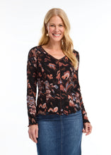 Load image into Gallery viewer, This long-sleeved V-neck top, adorned with a local artist's print, combines simplicity with style through its ribbed texture. It serves as a versatile piece for layering or as a standalone item. The scalloped hems at the bottom and cuffs enhance the design, and the colors are simply stunning.