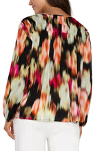 Load image into Gallery viewer, Experience the luxury of our Lilibet Long Sleeve V-neck Shirred Woven Blouse, boasting a stunning ruby floral print. Made with a lightweight woven fabric, this blouse provides effortless drape and exceptional comfort. Its long sleeves make it ideal for day-to-night wear, and the relaxed fit allows for unrestricted movement and all-day wearability.