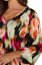 Load image into Gallery viewer, Experience the luxury of our Lilibet Long Sleeve V-neck Shirred Woven Blouse, boasting a stunning ruby floral print. Made with a lightweight woven fabric, this blouse provides effortless drape and exceptional comfort. Its long sleeves make it ideal for day-to-night wear, and the relaxed fit allows for unrestricted movement and all-day wearability.