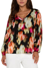 Load image into Gallery viewer, Experience the luxury of our Lilibet Long Sleeve V-neck Shirred Woven Blouse, boasting a stunning ruby floral print. Made with a lightweight woven fabric, this blouse provides effortless drape and exceptional comfort. Its long sleeves make it ideal for day-to-night wear, and the relaxed fit allows for unrestricted movement and all-day wearability.