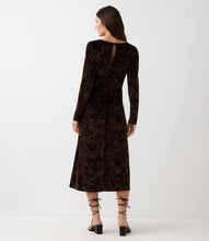 Load image into Gallery viewer, A woman viewed from the back wearing a long-sleeve midi dress in a dark brown, paired with black lace-up heels, against a plain white studio background.
