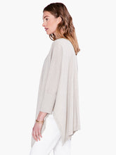 Load image into Gallery viewer, Worn open or tied at the front, this lightweight relaxed-fit cardigan brings draped comfort and style to any outfit. Designed to sit slightly below the hip with an 3/4 length sleeves. Made with a soft, breathable T-shirt yarn with metallic lurex added in to give it just the right amount of shine. Color- Light sand. Subtle sparkle throughout. Cape design. Lurex yarn, wear open or tied. Lightweight.