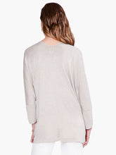 Load image into Gallery viewer, Worn open or tied at the front, this lightweight relaxed-fit cardigan brings draped comfort and style to any outfit. Designed to sit slightly below the hip with an 3/4 length sleeves. Made with a soft, breathable T-shirt yarn with metallic lurex added in to give it just the right amount of shine. Color- Light sand. Subtle sparkle throughout. Cape design. Lurex yarn, wear open or tied. Lightweight.