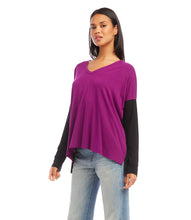 Load image into Gallery viewer, A modern look is achieved through the color blocked panels in this jersey-knit top. It's ideal for casual days, combining warmth and fashion. This top pairs well with any denim. Color- Magenta and black. Colorblock design. Long sleeve. Hi-low hem. Side-slits. Heavy Rayon Spandex: 90% Rayon. 10% Spandex. Care - Machine wash separately cold water or dry clean.