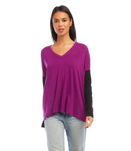 Load image into Gallery viewer, A modern look is achieved through the color blocked panels in this jersey-knit top. It's ideal for casual days, combining warmth and fashion. This top pairs well with any denim. Color- Magenta and black. Colorblock design. Long sleeve. Hi-low hem. Side-slits. Heavy Rayon Spandex: 90% Rayon. 10% Spandex. Care - Machine wash separately cold water or dry clean.