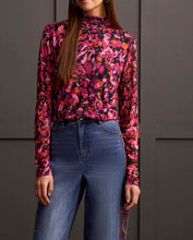 Load image into Gallery viewer, Our Maeve Magenta Haze Lined Turtleneck Top offers the perfect blend of comfort fused with contemporary style. Made from high quality, this turtleneck boasts a striking abstract design bringing a unique flair to your daily attire. Perfect for laid-back events or elegant affairs, this colorful top is sure to be a highlight in any trendsetting wardrobe.
