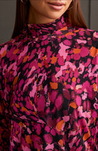 Load image into Gallery viewer, Our Maeve Magenta Haze Lined Turtleneck Top offers the perfect blend of comfort fused with contemporary style. Made from high quality, this turtleneck boasts a striking abstract design bringing a unique flair to your daily attire. Perfect for laid-back events or elegant affairs, this colorful top is sure to be a highlight in any trendsetting wardrobe.