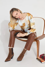 Load image into Gallery viewer, Crafted from two-way stretch Hammered Silk-Touch Satin, the Marie Blouse features an open neckline, asymmetrical front pleats, a high-low hemline, and double-box pleats on the sleeves for added volume. It fits true to size and pairs well with Ankle Elysse Vegan Leather pants in chalk and ankle boots. To remove any wrinkles after delivery, a gentle steaming or ironing is recommended.