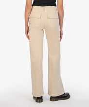 Load image into Gallery viewer, Elevate your style with these Meg Utility Pocket High Waist Wide Leg Pants from Kut from the Kloth (KB50101-BEIGE). Featuring a neutral beige color, flap pockets, and full-length wide legs, these pants add a professional touch to any outfit. With a high rise and 31-inch inseam, these pants provide a true to size fit and are both stylish and practical. Color- Beige. Front deep functional pockets. Back functional flap pockets. Wide leg. High rise. 31-inch inseam. Gold button closure. Belt loops.