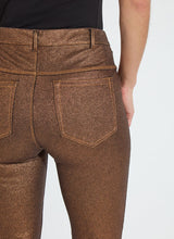 Load image into Gallery viewer, Crafted with a concealed patented waistband, beltloops, and hem slits adorned with gunmetal studs, the Melina Metallic Coated Straight Denim boasts an ankle-length fit. The 4x-stretch Knit Denim fabric is coated with a no-odor Polyurethane, offering the look and feel of vegan leather while retaining the same characteristics as our classic knit denim. These jeans feature a slim, fitted waist and hip, and a timeless straight leg silhouette that falls just at the ankle.