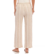 Load image into Gallery viewer, Discover a perfect blend of laid-back comfort and chic style with the Marlowe Metallic Stripe Drawstring Ankle Pants by Karen Kane. Crafted with lightweight gauze fabric, enhanced by delicate gold metallic accents, these pants are designed to elevate your everyday look. The drawstring waist ensures a customizable fit, while the ankle-length design adds a modern touch. Versatile and stylish, they're ideal for any springtime occasion.