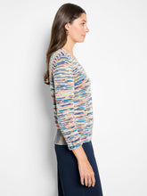 Load image into Gallery viewer, Woman wearing a colorful patterned long-sleeve sweater and navy pants against a white background.