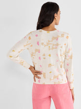 Load image into Gallery viewer, Woman wearing a cream sweater with pastel abstract print and pink pants against a white background.