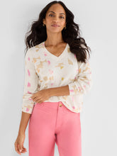 Load image into Gallery viewer, Woman wearing a cream sweater with pastel abstract print and pink pants against a white background.