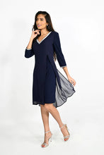 Load image into Gallery viewer, This beautiful V-neck dress comes in a luxurious navy shade with sparkling rhinestone trim along the front neckline and sleeves. The elegant chiffon split in the front offers a flowing look ideal for any special occasion. An absolute timeless classic. Color -Midnight blue with clear crystals. V-Neck. Chiffon overlay. Split fabrication in front. Crystal detailing at neckline and cuffs. Long sleeve. Knit/Woven Dress Fabric -95% Polyester. 5% Elasthane.