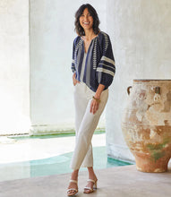 Load image into Gallery viewer, Lightweight cotton gives a breezy quality to this peasant top detailed with charming embroidery. This breezy top pairs perfectly with white pants for a fresh beachy look. Comes in both regular and plus sizes. Colors- Navy and white. Blouson sleeve V-neck Embroidered.