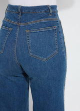 Load image into Gallery viewer, The Noah Hi Waist Crop Wide Fringe Denim is carefully crafted with two-color tobacco topstitching, a fringed hem, beltloops, back pockets, and a self-fringe insert on the side seams to provide an authentic denim look. Made from "Holding Power" Denim, this woven denim adapts to all shapes for maximum comfort and flattering fit. With a concealed patented waistband, two-way stretch, and pull-on styling, these must-have jeans are fitted through the waist and hip with a wide, cropped leg.