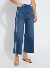 Load image into Gallery viewer, The Noah Hi Waist Crop Wide Fringe Denim is carefully crafted with two-color tobacco topstitching, a fringed hem, beltloops, back pockets, and a self-fringe insert on the side seams to provide an authentic denim look. Made from "Holding Power" Denim, this woven denim adapts to all shapes for maximum comfort and flattering fit. With a concealed patented waistband, two-way stretch, and pull-on styling, these must-have jeans are fitted through the waist and hip with a wide, cropped leg.