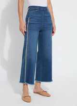Load image into Gallery viewer, The Noah Hi Waist Crop Wide Fringe Denim is carefully crafted with two-color tobacco topstitching, a fringed hem, beltloops, back pockets, and a self-fringe insert on the side seams to provide an authentic denim look. Made from "Holding Power" Denim, this woven denim adapts to all shapes for maximum comfort and flattering fit. With a concealed patented waistband, two-way stretch, and pull-on styling, these must-have jeans are fitted through the waist and hip with a wide, cropped leg.